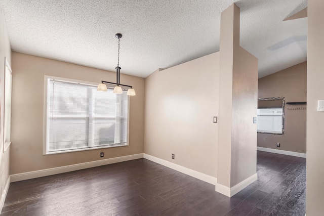 unfurnished dining area featuring a textured ceiling and dark hardwood / wood-style floors