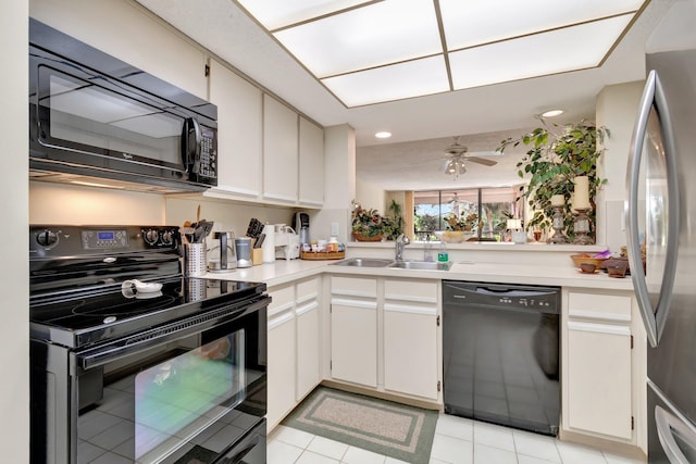 kitchen with ceiling fan, sink, light tile patterned floors, white cabinets, and black appliances