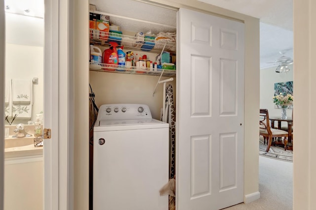 laundry room with ceiling fan, washer / dryer, and light colored carpet