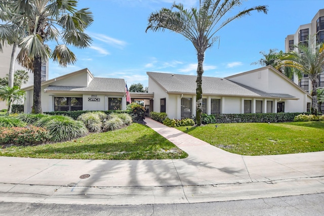 ranch-style house with a front lawn