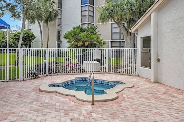 view of pool featuring an in ground hot tub and a patio