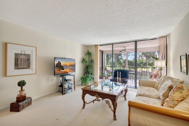 carpeted living room featuring a textured ceiling and ceiling fan