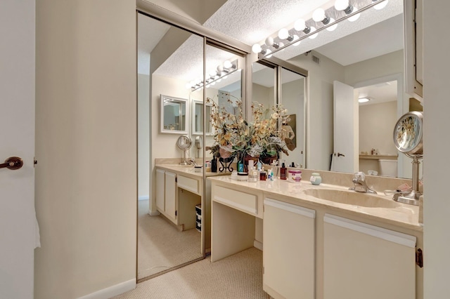 bathroom featuring vanity and a textured ceiling