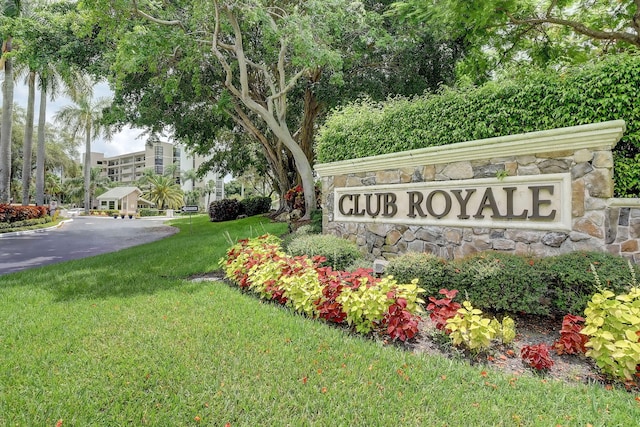 community / neighborhood sign with a lawn