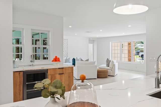 interior space with light stone counters and beverage cooler