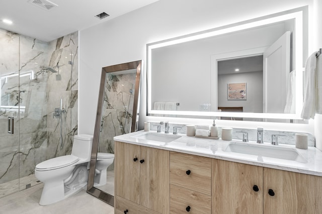 bathroom with vanity, toilet, and a shower with shower door