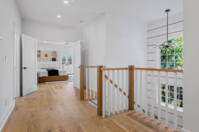 hall featuring light wood-type flooring and french doors