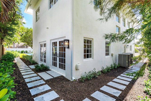 view of property exterior featuring central AC and french doors