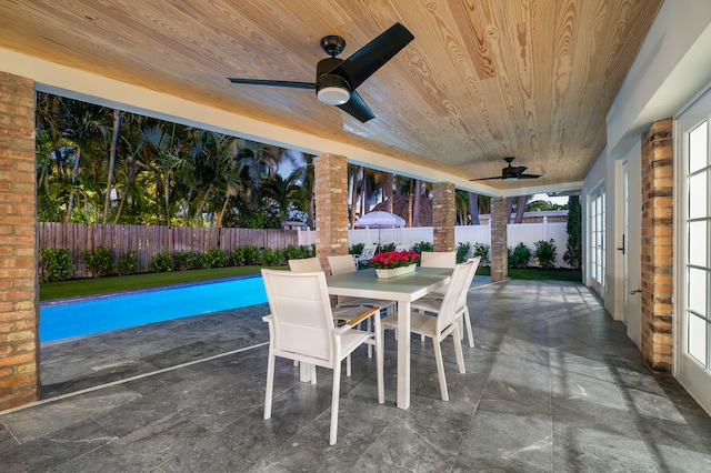 view of patio with french doors, a fenced in pool, and ceiling fan