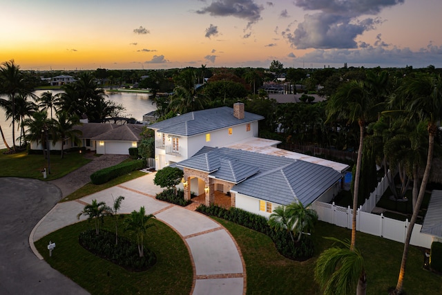 aerial view at dusk with a water view