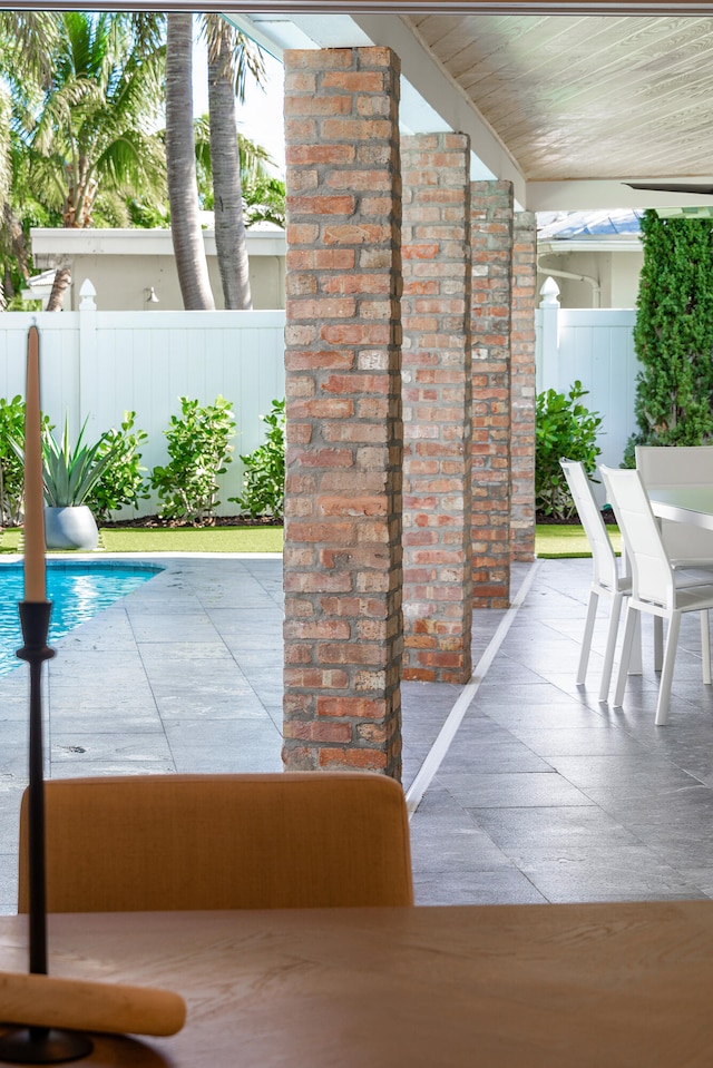 view of patio / terrace with a fenced in pool