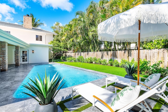 view of swimming pool with a yard and a patio area