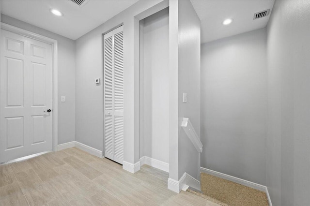 corridor with light hardwood / wood-style flooring