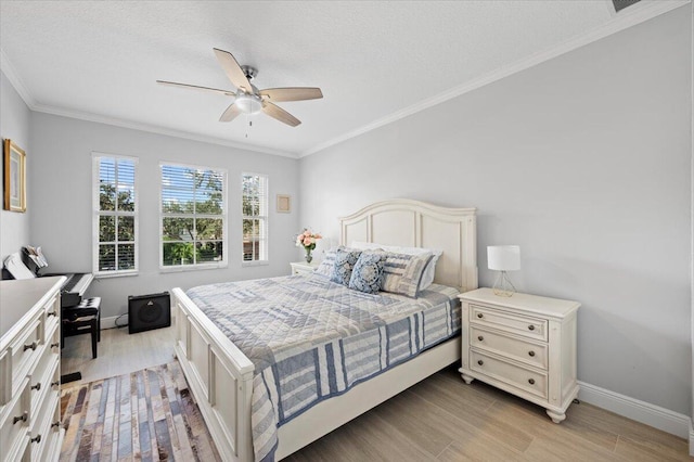 bedroom featuring a textured ceiling, light hardwood / wood-style flooring, ceiling fan, and ornamental molding