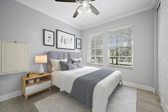 bedroom with ceiling fan, light hardwood / wood-style flooring, and ornamental molding