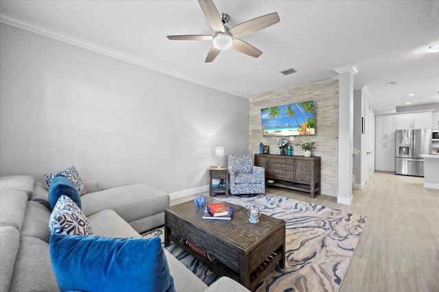 living room featuring ornate columns, ceiling fan, light hardwood / wood-style floors, and ornamental molding