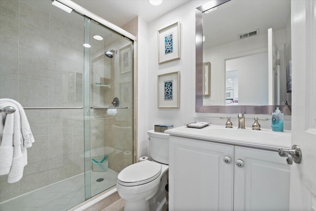 bathroom with vanity, an enclosed shower, and toilet