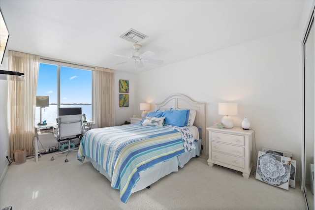 bedroom featuring ceiling fan, a closet, and light carpet