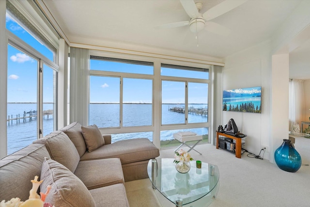 carpeted living room featuring ceiling fan and a wealth of natural light