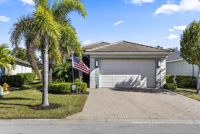 view of front of house featuring a garage and a front yard