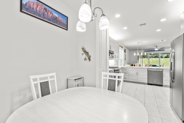 dining area with light tile patterned floors and ceiling fan