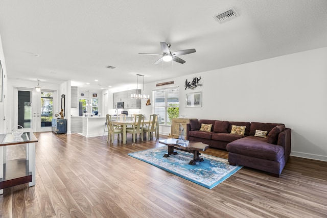 living room featuring hardwood / wood-style floors, french doors, a wealth of natural light, and ceiling fan