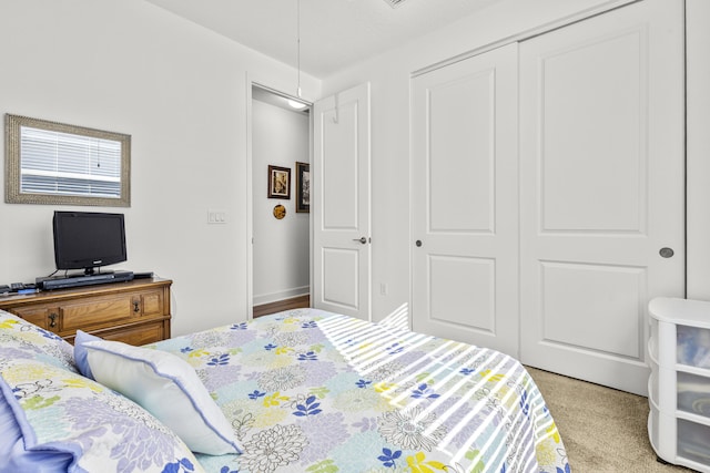 carpeted bedroom featuring a closet