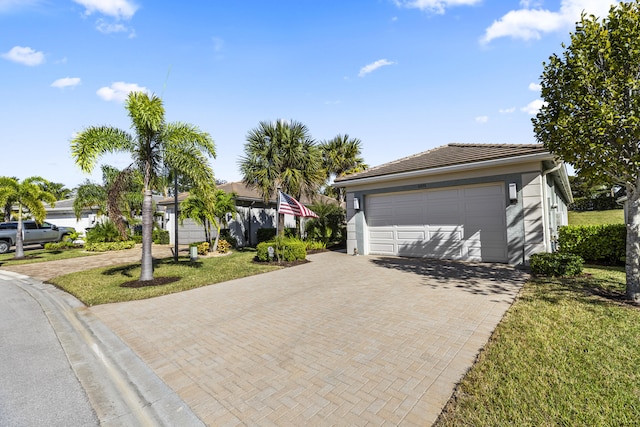 single story home with a front lawn and a garage