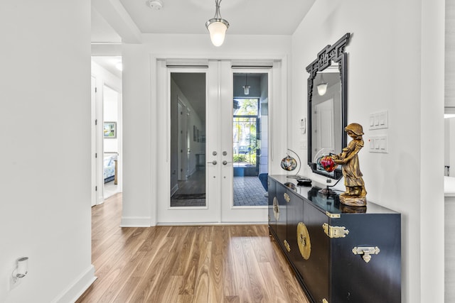 entryway with wood-type flooring and french doors