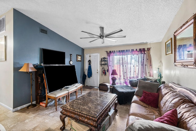 living room with ceiling fan, vaulted ceiling, and a textured ceiling