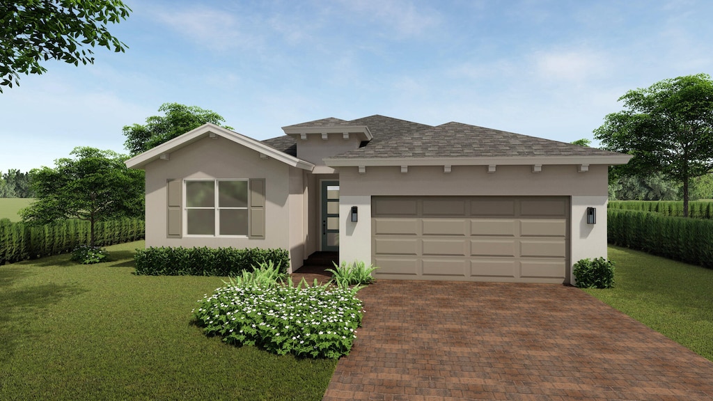 view of front facade with a garage and a front lawn