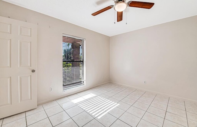 tiled empty room with ceiling fan