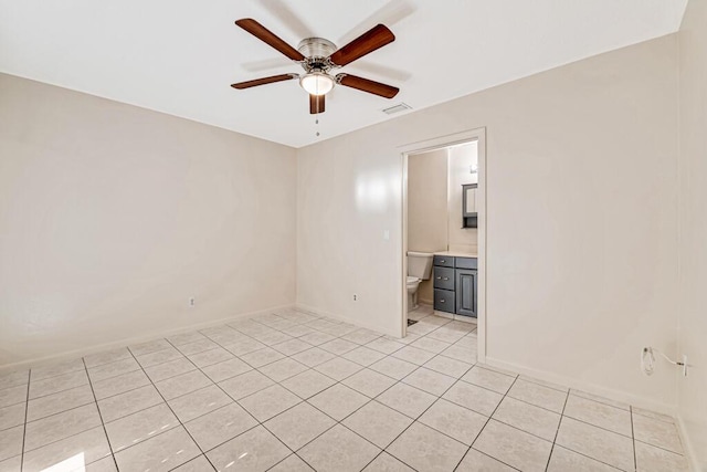 tiled empty room featuring ceiling fan