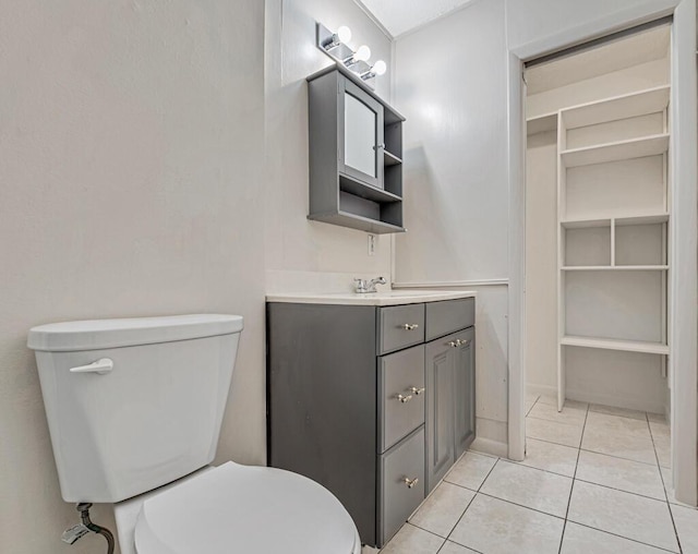 bathroom featuring tile patterned flooring, vanity, and toilet