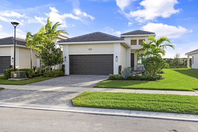 view of front of home with a front yard and a garage