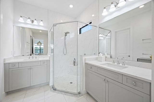 bathroom featuring a shower with door and vanity