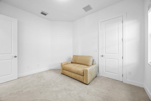 sitting room featuring light colored carpet