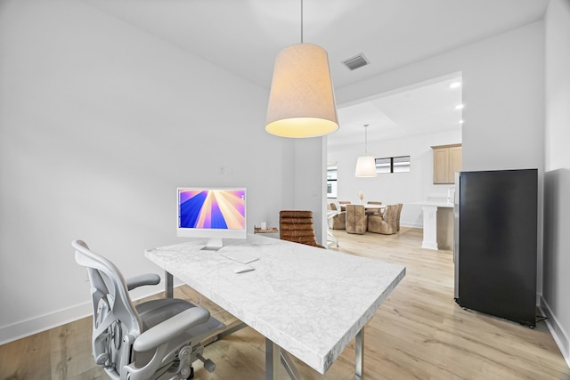 office with light hardwood / wood-style flooring