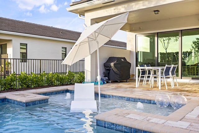 view of pool featuring pool water feature and grilling area