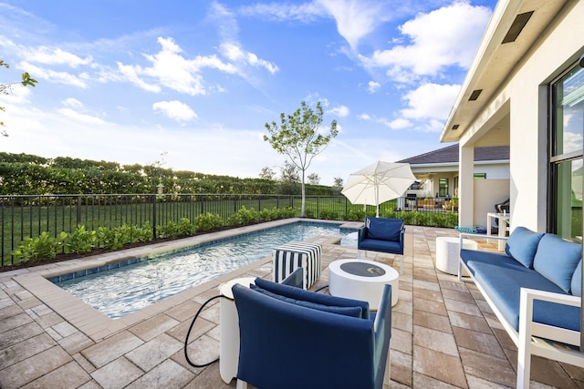 view of pool featuring outdoor lounge area and a patio