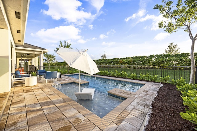 view of pool with pool water feature, ceiling fan, and a patio