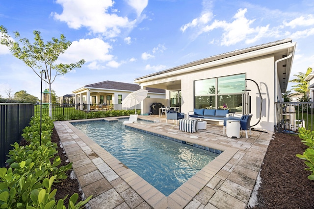 view of swimming pool featuring an outdoor living space and a patio