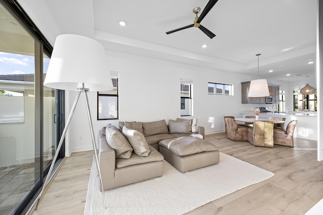 living room featuring ceiling fan and light wood-type flooring