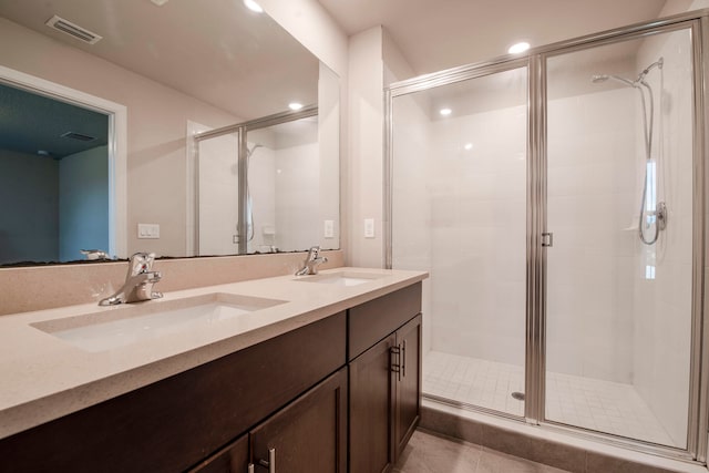 bathroom featuring tile patterned floors, vanity, and walk in shower