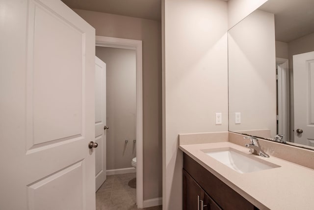 bathroom featuring tile patterned floors, vanity, and toilet