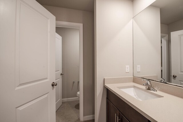 6341 Topsail Dr, West Palm Beach, FL 33413 - bathroom featuring toilet, vanity, tile patterned floors, and baseboards