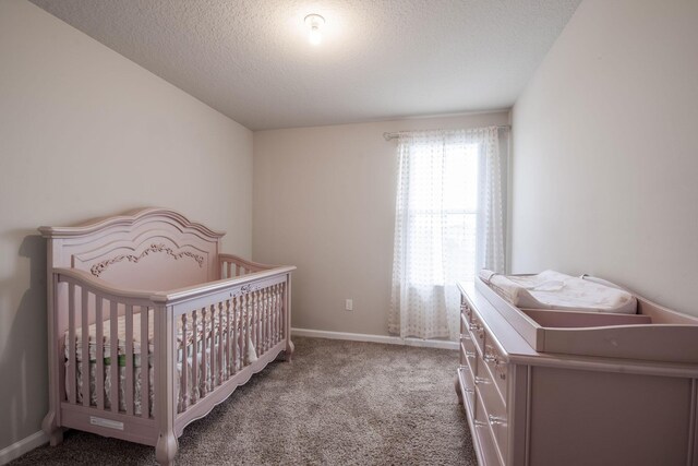 6341 Topsail Dr, West Palm Beach, FL 33413 - bedroom with carpet flooring, baseboards, a textured ceiling, and a nursery area