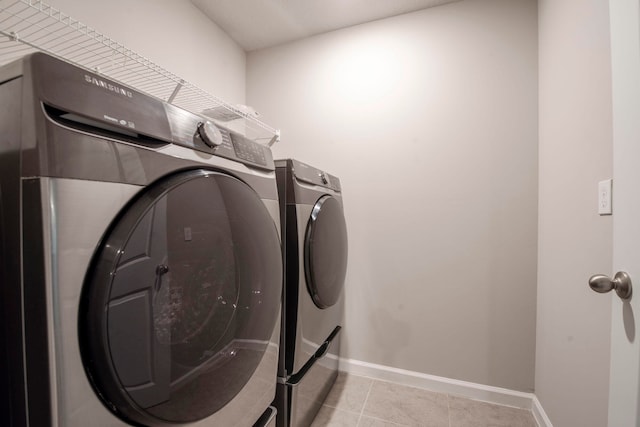 washroom featuring light tile patterned floors and washer and dryer