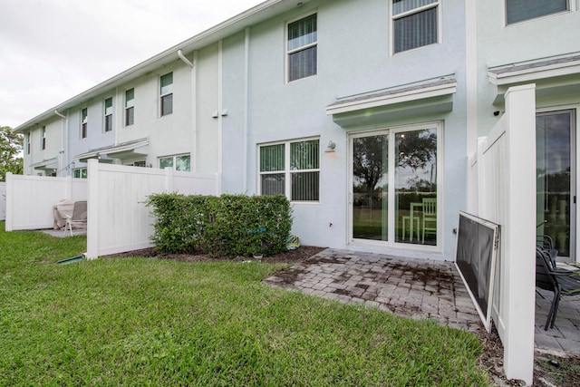 rear view of property featuring a lawn