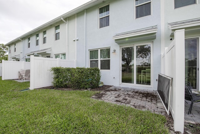 6341 Topsail Dr, West Palm Beach, FL 33413 - back of property featuring stucco siding and a patio